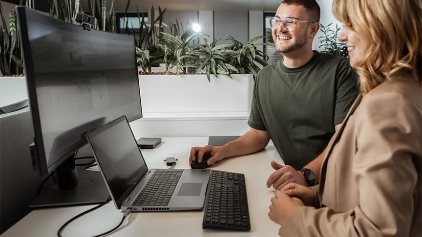 Two employees looking at a screen